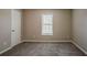 This is a cozy bedroom with neutral carpet, a window with blinds, and light-colored walls at 5589 Claridge Cir, Lithonia, GA 30038