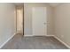 Carpeted bedroom with neutral paint and door leading to ensuite bath at 5589 Claridge Cir, Lithonia, GA 30038