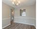 Elegant dining room with modern light fixture and decorative wall molding at 5589 Claridge Cir, Lithonia, GA 30038