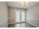 Dining room with chandelier lighting and French doors that lead to the outdoor space at 5589 Claridge Cir, Lithonia, GA 30038