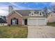 Charming two-story home featuring a brick accent, vinyl siding, and a convenient two-car garage at 5589 Claridge Cir, Lithonia, GA 30038