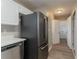 Modern kitchen showing stainless steel refrigerator and dishwasher, and easy access to laundry room at 5589 Claridge Cir, Lithonia, GA 30038