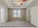 Spacious main bedroom featuring a tray ceiling, large window, and plush carpeting at 5589 Claridge Cir, Lithonia, GA 30038