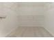 Walk-in closet with ample shelving for organized storage, ensuring functionality and convenience at 5589 Claridge Cir, Lithonia, GA 30038