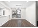 Bright dining area with sleek wood flooring and modern lighting fixtures, adjacent to the kitchen at 1307 Wynnes Ridge Se Cir, Marietta, GA 30067