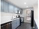 Modern kitchen features stainless appliances, light blue cabinets, white backsplash, and tile floors at 1307 Wynnes Ridge Se Cir, Marietta, GA 30067