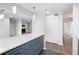 Kitchen island with white countertop and blue cabinets opens to living room with fireplace at 1307 Wynnes Ridge Se Cir, Marietta, GA 30067