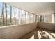 Relaxing screened-in porch with wooden floor overlooking a wooded area, perfect for enjoying nature at 1307 Wynnes Ridge Se Cir, Marietta, GA 30067