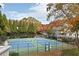 Scenic view of community tennis courts surrounded by mature trees with colorful fall foliage at 1307 Wynnes Ridge Se Cir, Marietta, GA 30067