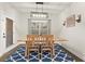 Dining room with modern light fixture, wooden table, chairs, and blue patterned rug at 2316 Ridge View Dr, Loganville, GA 30052