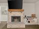 Elegant brick fireplace with a wooden mantel and built-in storage at 2316 Ridge View Dr, Loganville, GA 30052