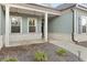 Inviting front porch with brick accents and decorative hanging lights at 2316 Ridge View Dr, Loganville, GA 30052