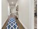 Hallway with hardwood floors, blue patterned rug, and console table with mirror at 2316 Ridge View Dr, Loganville, GA 30052