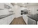 Bright, open kitchen featuring white cabinetry, stainless steel appliances, and dark countertops at 2316 Ridge View Dr, Loganville, GA 30052