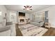 Cozy living room with a brick fireplace, plush seating, and a large window at 2316 Ridge View Dr, Loganville, GA 30052