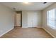 Bedroom featuring double doors and a light colored wall at 4060 Rockmill Cv, Ellenwood, GA 30294