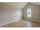 Bedroom with light-colored walls, wood-look floors, an arched window and a vaulted ceiling at 4060 Rockmill Cv, Ellenwood, GA 30294