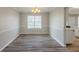 Dining area features hardwood floors, chair rail and modern chandelier at 4060 Rockmill Cv, Ellenwood, GA 30294