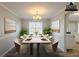 Staged dining room with table setting and contemporary decor at 4060 Rockmill Cv, Ellenwood, GA 30294