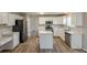 Modern kitchen features stainless steel appliances, an island, hardwood floors and plenty of counter space at 4060 Rockmill Cv, Ellenwood, GA 30294