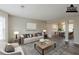 Virtually staged living room with modern furnishings and a view into the dining area at 4060 Rockmill Cv, Ellenwood, GA 30294