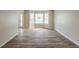 Bright living room with a bay window and modern wood flooring, ready for personalization at 4060 Rockmill Cv, Ellenwood, GA 30294