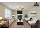 Staged living room featuring a fireplace, hardwood floors, lots of natural light and contemporary furnishings at 4060 Rockmill Cv, Ellenwood, GA 30294