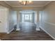 Open living room with hardwood floors, chair rail and lots of natural light at 4060 Rockmill Cv, Ellenwood, GA 30294