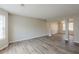 Open-concept living room with modern flooring, neutral paint, and lots of natural light at 4060 Rockmill Cv, Ellenwood, GA 30294