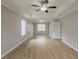 Bright bedroom with tray ceiling, a ceiling fan, and access to an ensuite bathroom at 4060 Rockmill Cv, Ellenwood, GA 30294