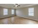 Spacious bedroom with tray ceiling, a ceiling fan, and many windows with blinds at 4060 Rockmill Cv, Ellenwood, GA 30294