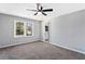 Bedroom featuring plush carpet, ceiling fan, and ensuite at 67 Blue Springs Sw Ct, Lilburn, GA 30047