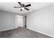 Spacious bedroom featuring plush carpet, ceiling fan, and closet at 67 Blue Springs Sw Ct, Lilburn, GA 30047