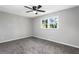 Bedroom with soft gray carpet, a ceiling fan, and a sunny window at 67 Blue Springs Sw Ct, Lilburn, GA 30047