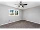 Cozy bedroom with a ceiling fan and a large window at 67 Blue Springs Sw Ct, Lilburn, GA 30047