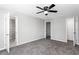 Bedroom featuring plush carpet, ceiling fan, closet, and ensuite at 67 Blue Springs Sw Ct, Lilburn, GA 30047