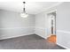 Dining room with gray walls, crown molding, neutral carpet, and a view to the hall at 67 Blue Springs Sw Ct, Lilburn, GA 30047