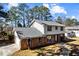 Charming home featuring a front-facing garage and a well-maintained lawn at 67 Blue Springs Sw Ct, Lilburn, GA 30047