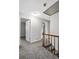 Hallway with grey carpet and white trim, plus doors leading to bedrooms at 67 Blue Springs Sw Ct, Lilburn, GA 30047