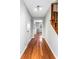 Hallway with gleaming hardwood floors, staircase, and leading to the updated kitchen at 67 Blue Springs Sw Ct, Lilburn, GA 30047