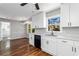 Renovated kitchen featuring white cabinets, hardwood floors, and a modern sink at 67 Blue Springs Sw Ct, Lilburn, GA 30047