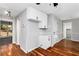 Bright kitchen with gray walls, hardwood floors, and white cabinetry at 67 Blue Springs Sw Ct, Lilburn, GA 30047