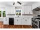 Bright kitchen with white cabinetry, stainless steel appliances, and hardwood floors at 67 Blue Springs Sw Ct, Lilburn, GA 30047