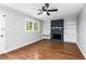 Inviting living room featuring a brick fireplace, built-in shelves, and hardwood floors at 67 Blue Springs Sw Ct, Lilburn, GA 30047