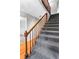 Carpeted staircase with wood railing and trim, offering a view of the home's interior at 67 Blue Springs Sw Ct, Lilburn, GA 30047