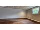 Bright finished basement with laminate floors and a window at 1325 Classic Ne Dr, Conyers, GA 30013