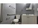 Bathroom with a sink and vanity, toilet and handrails on the wall at 1325 Classic Ne Dr, Conyers, GA 30013