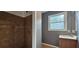 Bathroom featuring tiled shower and vanity with natural light at 1325 Classic Ne Dr, Conyers, GA 30013