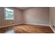Bedroom featuring warm hardwood floors, neutral walls, and a bright window at 1325 Classic Ne Dr, Conyers, GA 30013