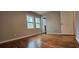 Bedroom with wood floors, two windows for natural light, and neutral walls at 1325 Classic Ne Dr, Conyers, GA 30013